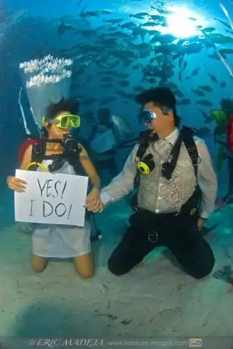 A couple renewing vows at the Mabul Water Bungalows fish sanctuary.