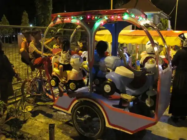Pedal-powered rides for children, Nunukan town square.