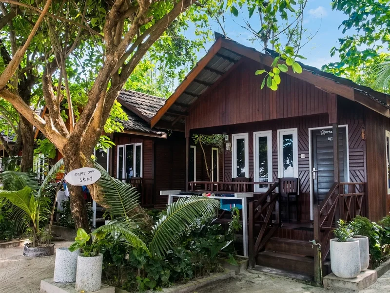 Traditional standalone chalet set within the resort's beautiful garden environment.