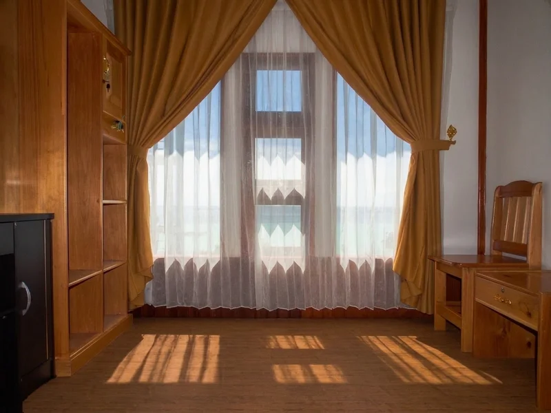 Well-maintained standard interior with air-conditioning and simple wooden furnishings.