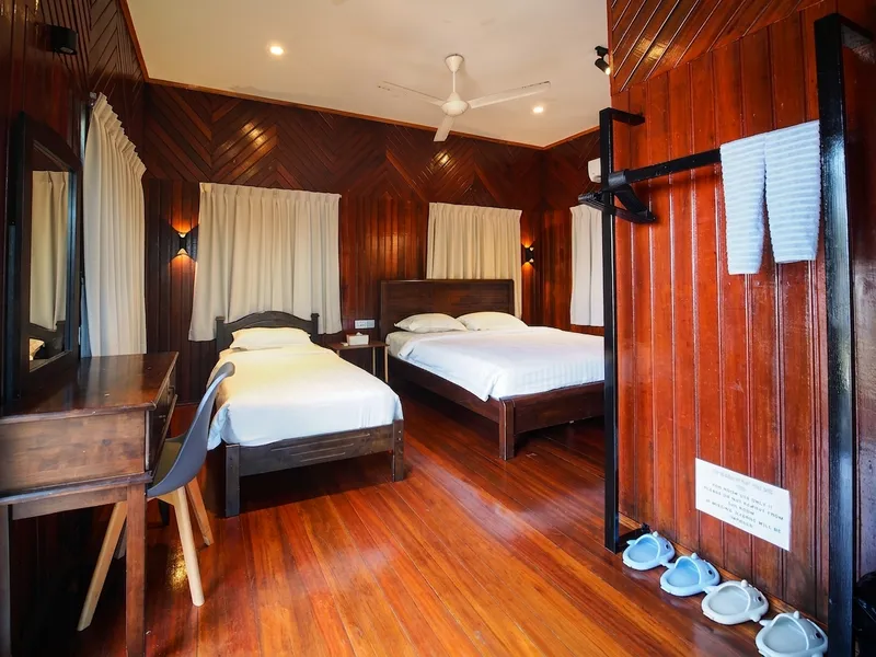 The premium Buwan Chalet offers a spacious living area with direct views of the sea from the bed.