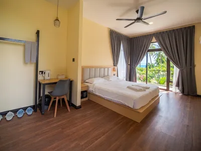 Quiet Garden Deluxe interior with large windows and a clean, airy layout.