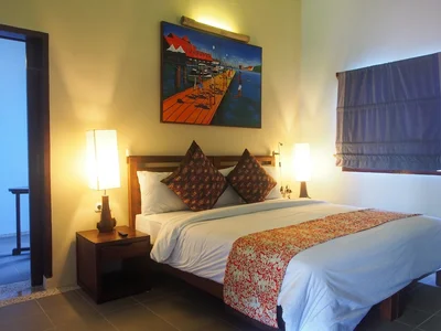 Premium Junior Suite bedroom with high-end finishes and sea views.