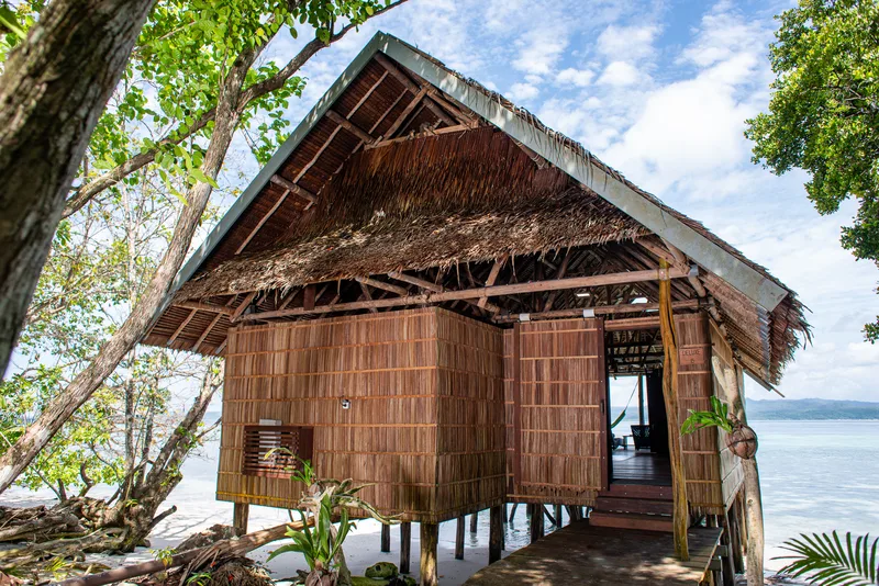Traditionally built Deluxe water bungalow standing on the beachfront.