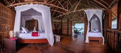 Premium Deluxe interior featuring hand-made furnishings and elegant Papuan design.