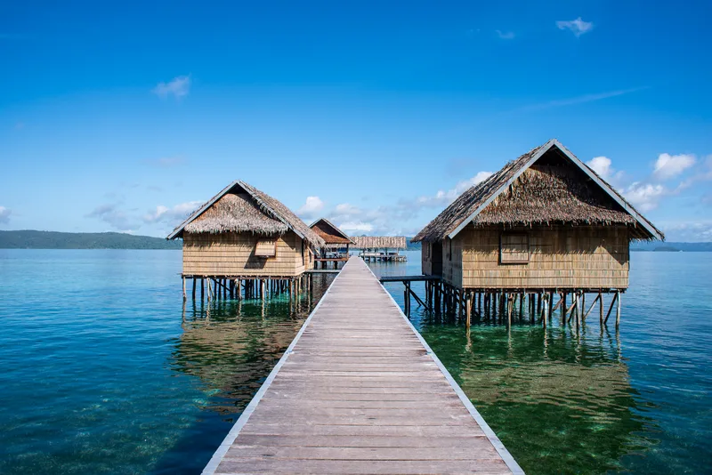 Authentic Papuan-style water bungalow standing gracefully on stilts.