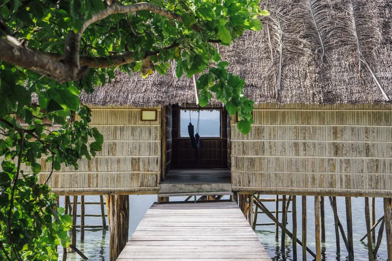 Beachfront cottage placement offering direct access to the clear Papuan waters.