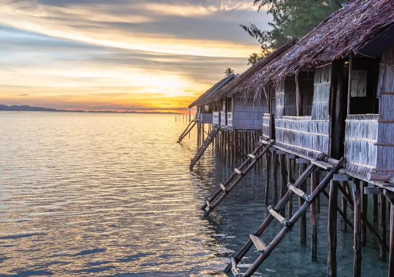 Traditional Papuan wooden staircase leading from the beach to the cottage.