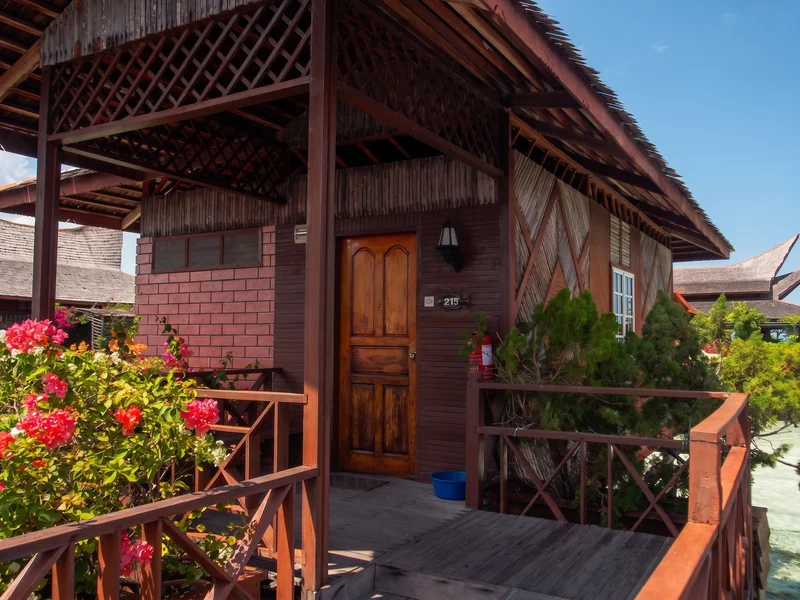Signature wooden bungalow built on stilts over the ocean.