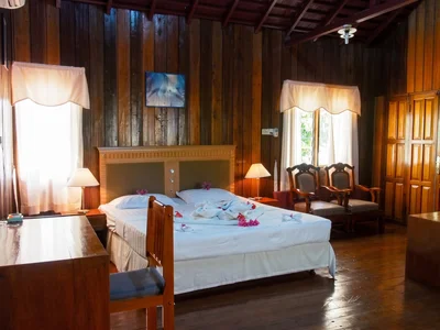 Clean and comfortable Beach Chalet interior featuring a small seating area and wooden finishes.