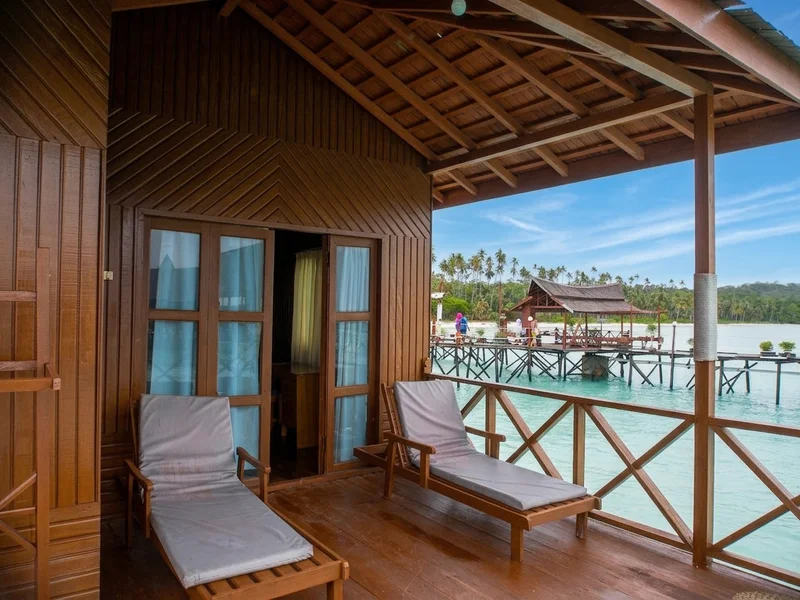 Private sea-view balcony with deck chairs, perfect for enjoying the panoramic ocean horizons.