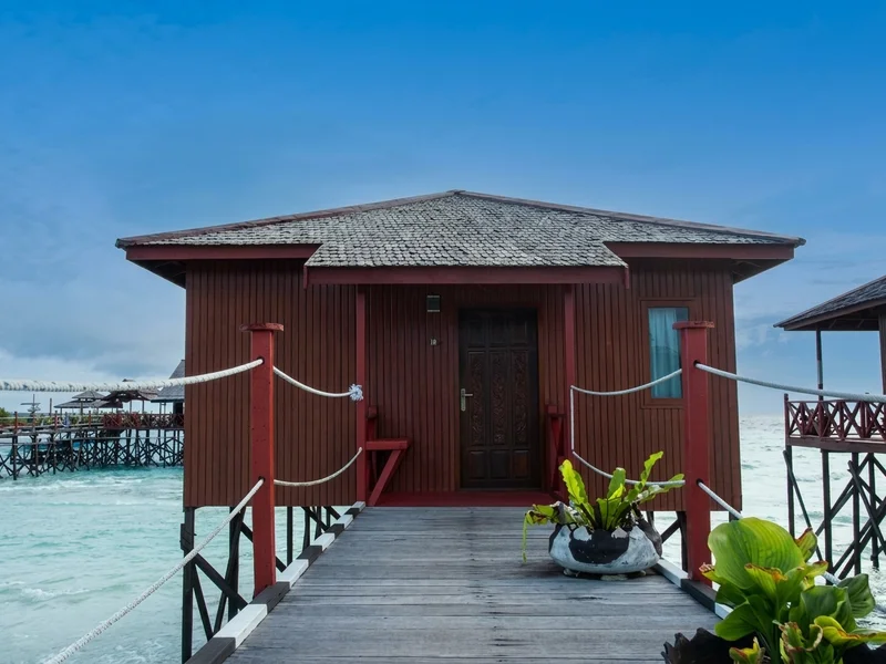 Wooden walkway leading to the entrance of the exotic over-water villas.
