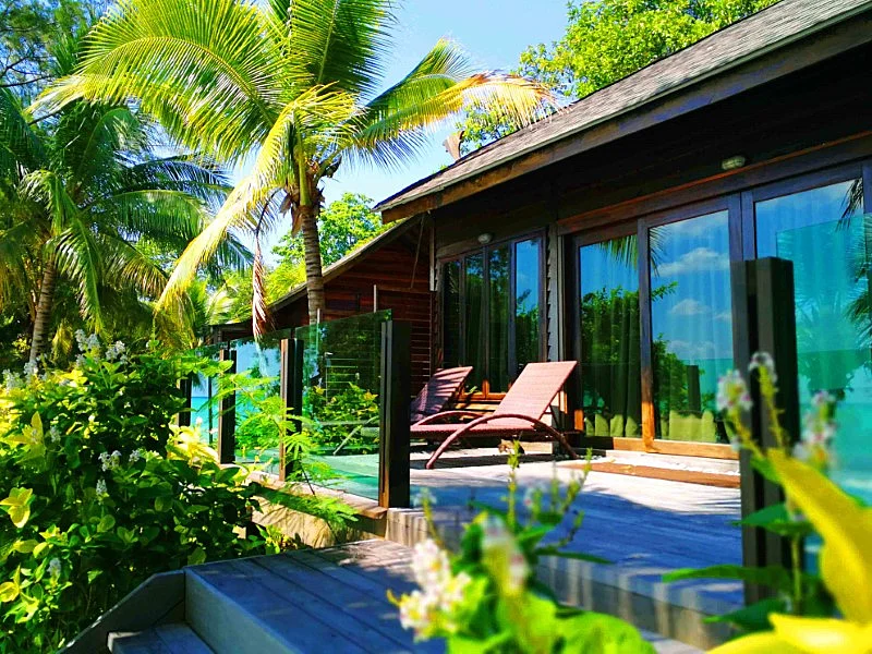 Private balcony area facing the white sandy beach and crystal clear water.
