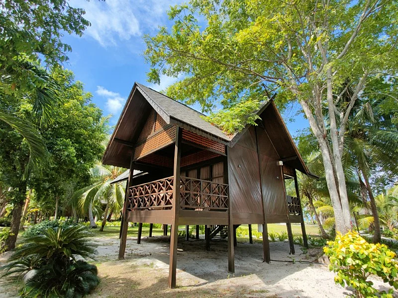 Traditional standalone bungalow exterior on stilts overlooking the beach.