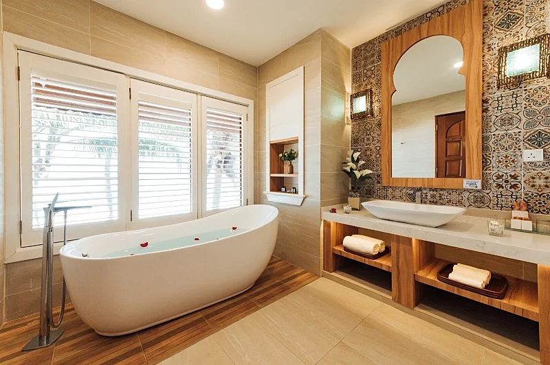 En-suite bathroom featuring a bathtub with a stunning view of the sea.