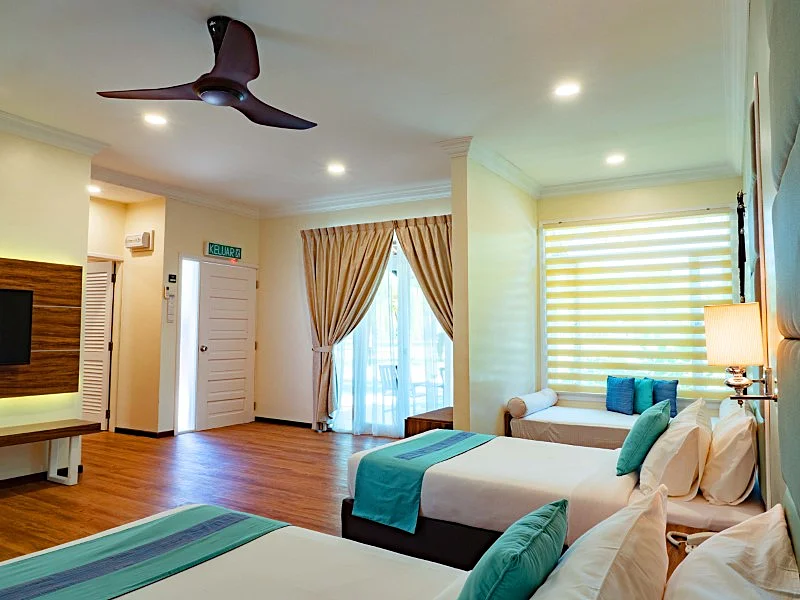 Large windows opening to a private garden view from the Premium room.
