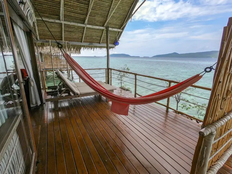 Relaxing terrace area with sun loungers and easy access to the house reef.