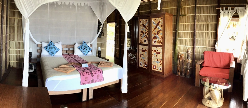 Comfortable bedroom area featuring local materials and a mosquito net.