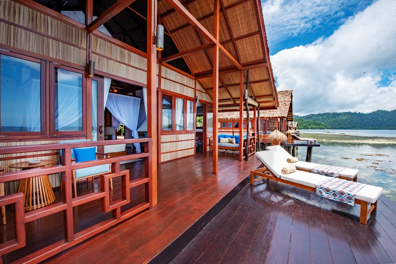 Large two-tier private balcony of the Premiere bungalow with a dedicated day bed.