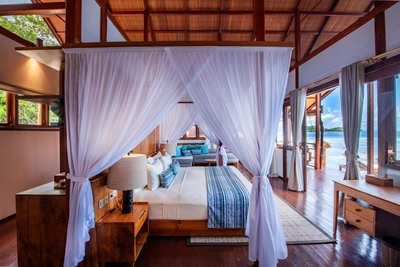 Premiere bungalow master bedroom with a luxurious 4-poster king-size bed.