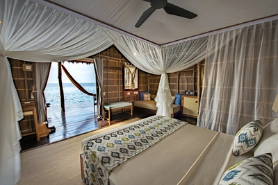 Traditional Papuan-style interior of the Superior bungalow with solid wood furniture.