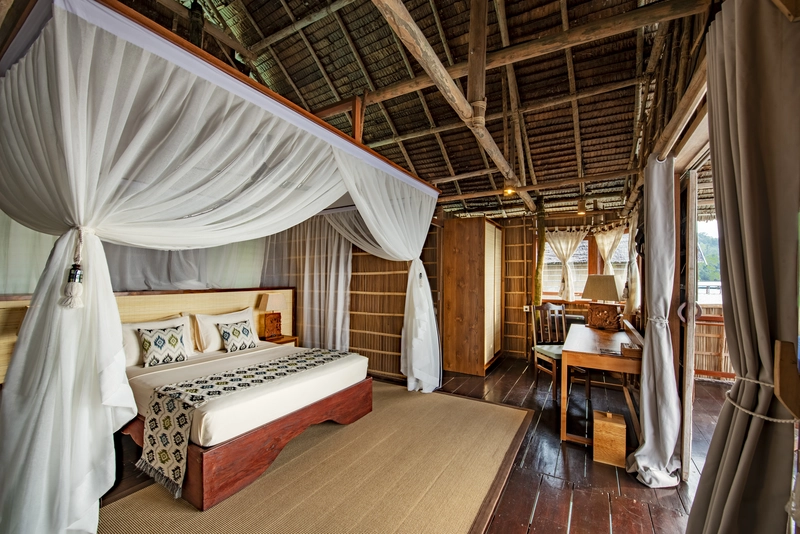Well-lit bedroom space with natural materials and a ceiling fan.