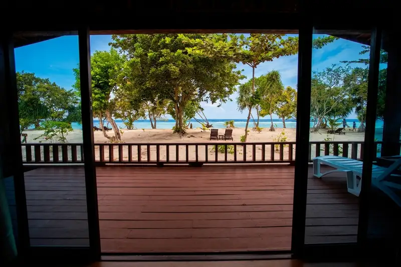 Large private balcony equipped with comfortable chairs and sea views.