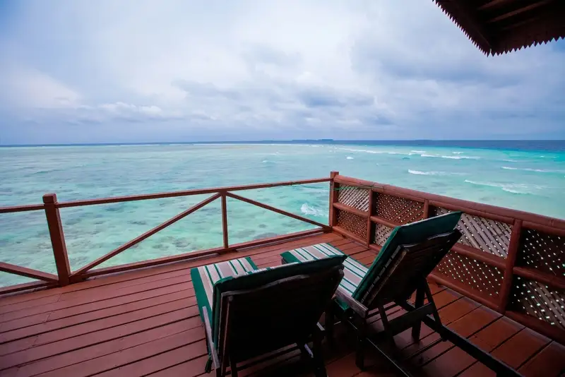 Private over-water balcony with sun beds for ultimate relaxation.
