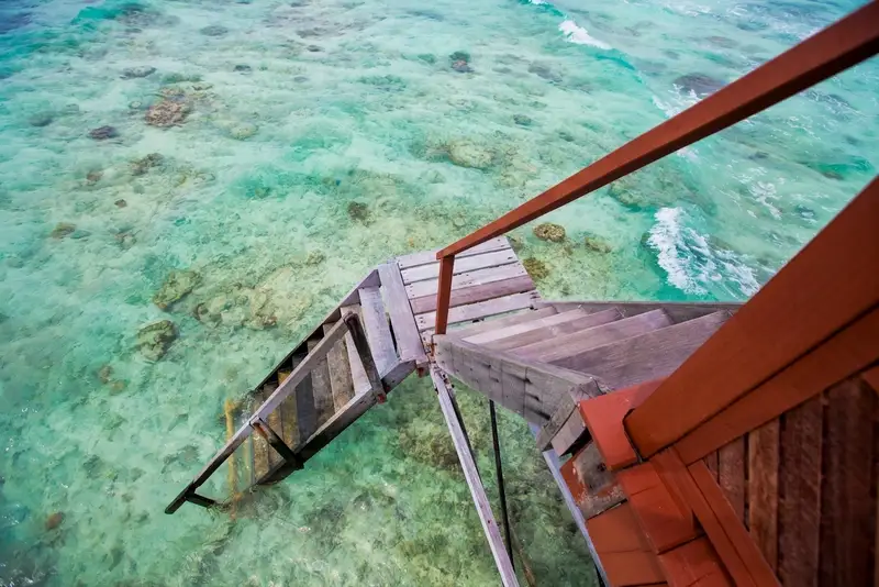 Direct access to the crystal clear lagoon from your private villa deck.