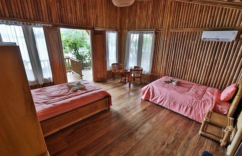 Clean and minimalist ensuite bathroom facilities within the beachfront bamboo cottage.