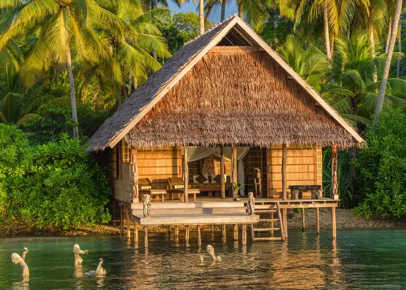 Traditional water bungalow on stilts, offering direct access to the sea.