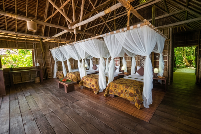 Authentic Papuan-style interior with high ceilings and local timber finishes.