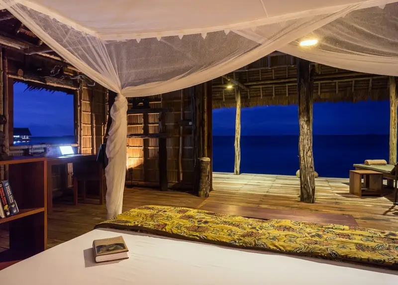 Spacious and airy living space featuring a comfortable double bed and mosquito net.