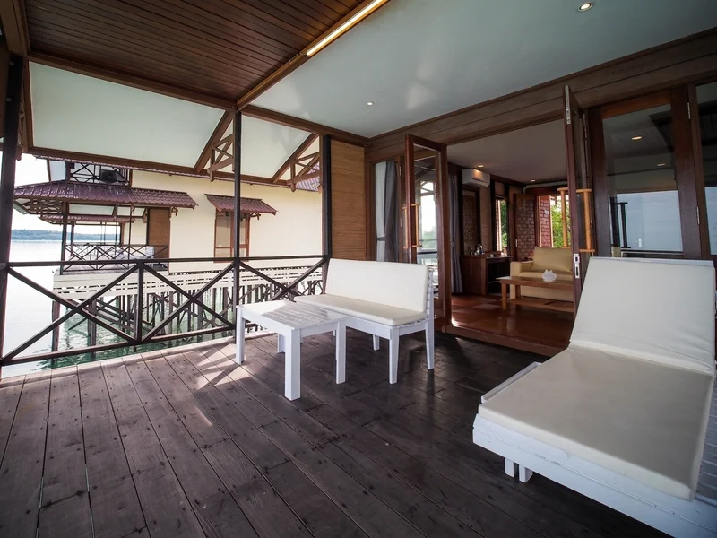 Expansive lower veranda offering direct views of the turquoise lagoon.