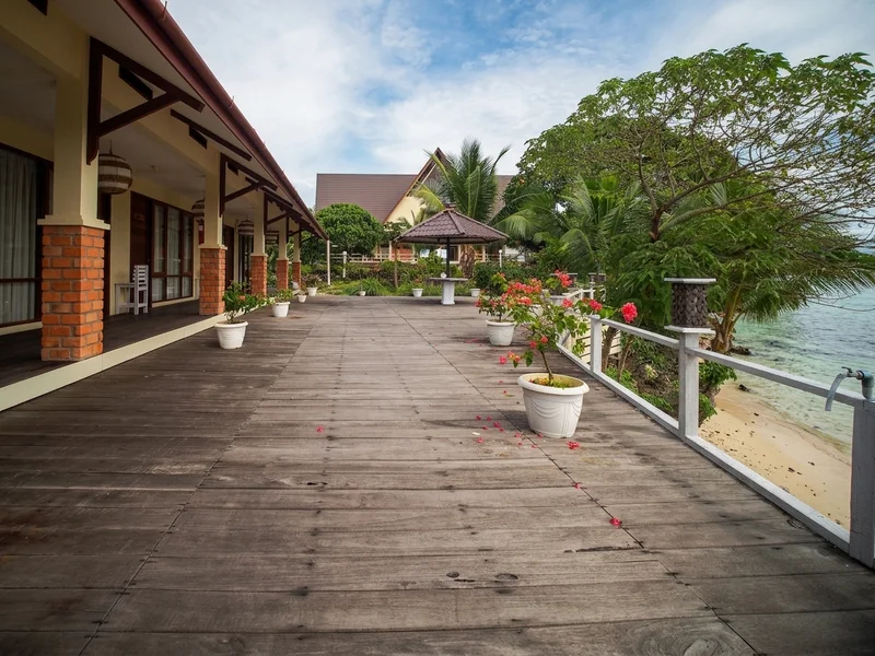Scenic view of the Sidau Cottages nestled among lush island forest.