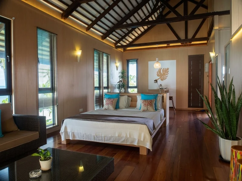 Spacious and airy master bedroom with local timber finishes.
