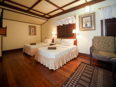 Comfortable standalone chalet interior featuring native Borneo timber and oversized beds.