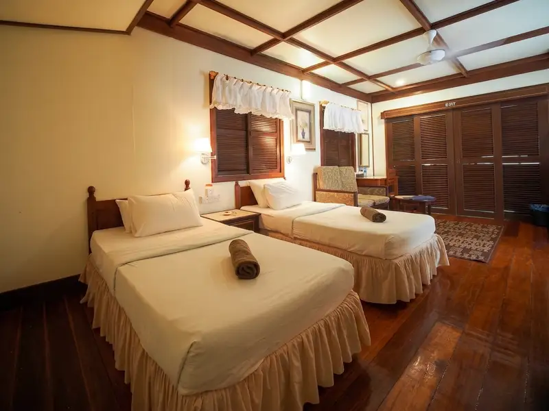 Bright and airy bedroom area with traditional furnishings and air-conditioning.
