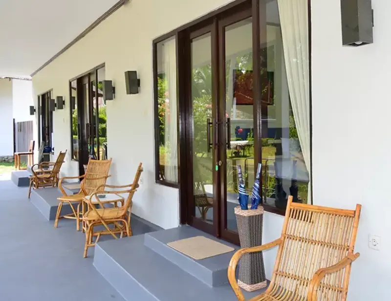 Exterior view of the Garden Rooms, set back from the waterfront in a lush tropical setting.