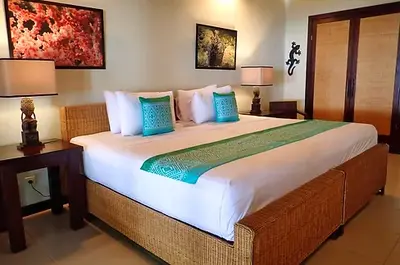 Bright and airy Seafront Villa interior with a king-size bed and modern Papuan-style design.