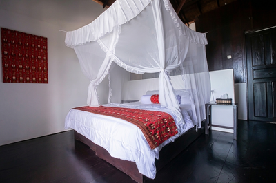 Large Beachfront Deluxe interior featuring elegant Indonesian design.