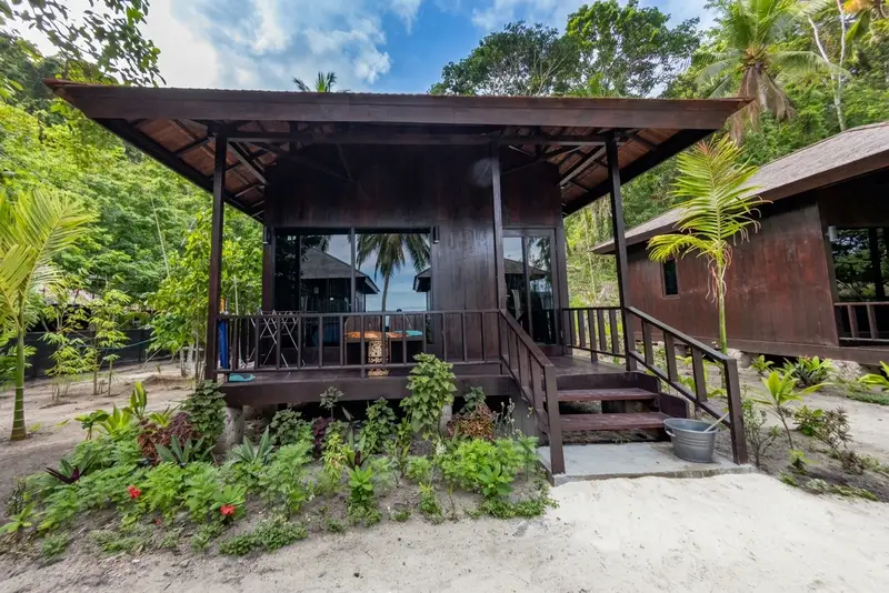 Secluded bungalow exterior nestled among the lush island forest.