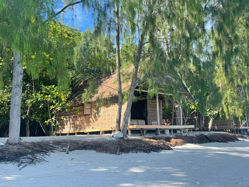 Scenic row of bungalows nestled along the pristine white sand beach.