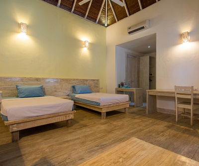 Bright and modern Garden View Room interior with whitewashed walls.